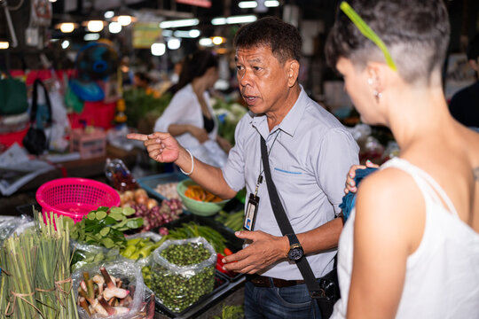 Tour guide showing a food market.