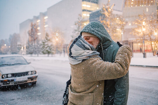 Tender Kiss Amidst a snowfall in the empty city