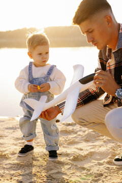 Son father playing toys nurturing family ties landscape lake forest