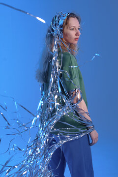 Woman covering with flying silver tinsel