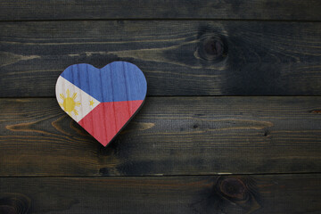 wooden heart with national flag of philippines on the wooden background.