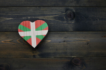 wooden heart with national flag of basque country on the wooden background.