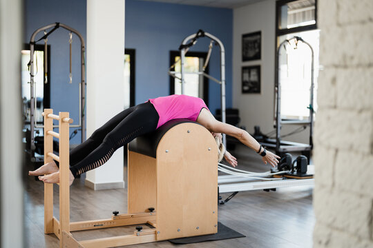 A mature woman doing postural exercises in a gym
