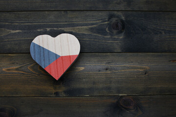wooden heart with national flag of czech republic on the wooden background.