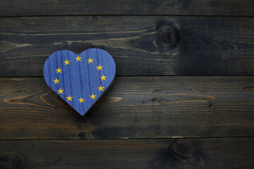 wooden heart with national flag of european union on the wooden background.