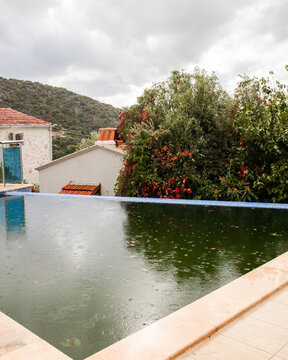 Swimming pool in rainy weather in autumn/ winter time 