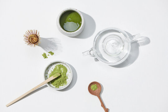 Green tea matcha powder in ceramic bowl, traditional bamboo
