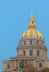 Dome des Invalides with statue of Fayolle in front against blue sky on an clear day in November in Paris, France