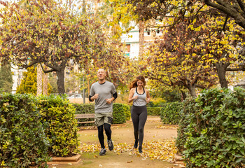 two friends doing sports in the city park
