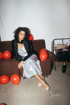 Elegant Woman in Sequin Dress with Red Balloons