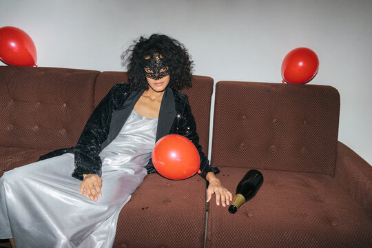After Party Scene: Woman in Mask with Balloons and Champagne