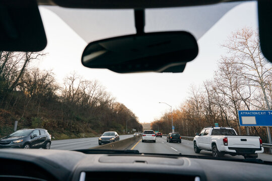 Cars driving down a busy highway. 