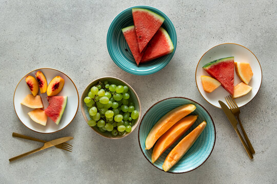 Fresh fruits for breakfast - watermelon, melon, grape, peach on table