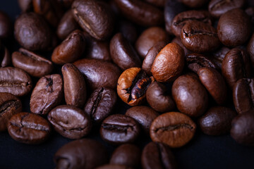 Coffee Beans in studio on a black table background with contrast and deep colors