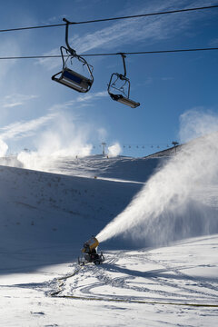 Chairlift with snow cannon in operation