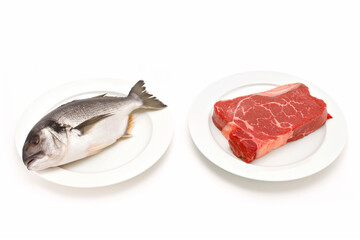 A fish and a piece of meat are displayed on separate plates