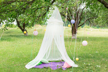 location in nature. the canopy baldachin on the tree with ribbons lanterns © Svetlana