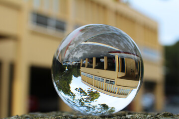 Building reflection in the glass sphere