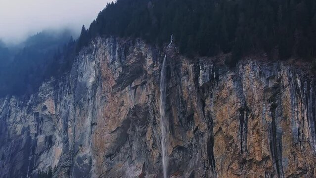 Beautiful aerial view of the Staubbach Falls in Switzerland. Magical panoramic aerial view of Switzerland during cloudy weather.