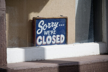 Sorry we are closed sign in shop window