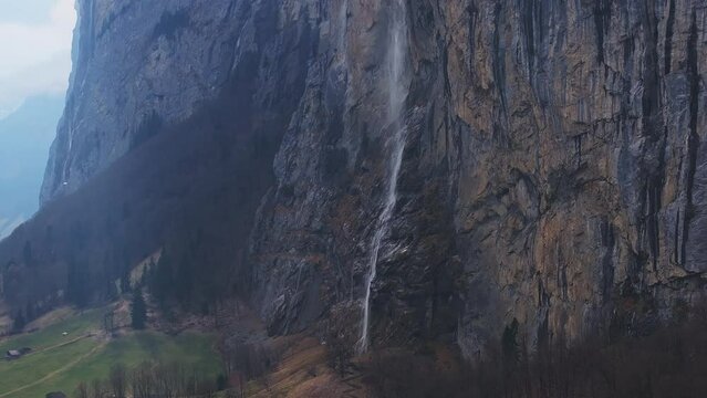 Beautiful aerial view of the Staubbach Falls in Switzerland. Magical panoramic aerial view of Switzerland during cloudy weather.