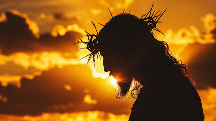 Jesus Christ with crown of thorns on his head against sunset sky - obrazy, fototapety, plakaty