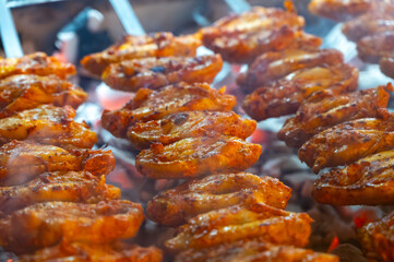 Turkish mixed grill meat, chicken wings, lamb, beef shashlik, kebab cooking on charcoal grill in restaurant