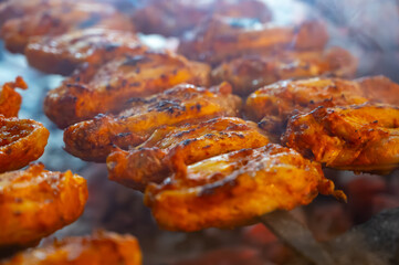 Turkish mixed grill meat, chicken wings, lamb, beef shashlik, kebab cooking on charcoal grill in restaurant