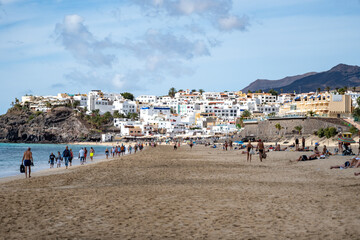 White sandy beach and blue ocean water in Morro Jable vacation village on south of Fuerteventura, Canary islands, Spain