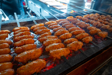 Turkish mixed grill meat, chicken wings, lamb, beef shashlik, kebab cooking on charcoal grill in restaurant