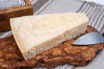 Traditional italian food - 22 months aged in caves Italian parmesan hard cheese from Parmigiano-Reggiano, Italy