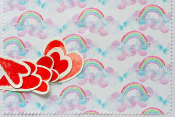 decorative cloth with rainbows and paper hearts