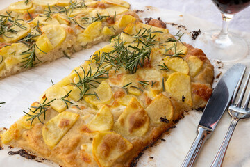 Fresh baked focaccia or pala romana pizza with potato vegetables and rosemary in bakery in Parma, Emilia Romania, Italy
