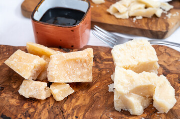 Tasting of 24 and 48 months aged Italian parmesan hard cheese from Parmigiano-Reggiano, Italy and balsamico vinegar from Modena