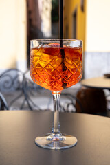 Aperol Spritz orange bitter long drink cocktail made with liqueur, prosecco sparkling wine, ice cubes and piece of orange, Milan, Italy