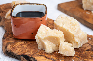 Tasting of 24 and 48 months aged Italian parmesan hard cheese from Parmigiano-Reggiano, Italy and balsamico vinegar from Modena