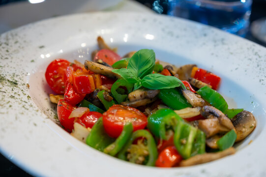 Vegetarian dishes, mezze in Turkish restaurant, grilles mushrooms, pepper and fresh vegetables salad