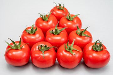 Food triangle, Red ripe tasty Dutch tomatoes, vegetables background top view close up copy space