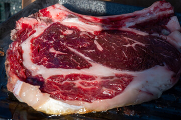 Large beef rib eye steak grilled on gas stove grill in small village restaurant in Italy