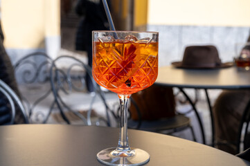 Aperol Spritz orange bitter long drink cocktail made with liqueur, prosecco sparkling wine, ice cubes and piece of orange, Milan, Italy