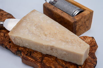 Traditional italian food - 22 months aged in caves Italian parmesan hard cheese from Parmigiano-Reggiano, Italy