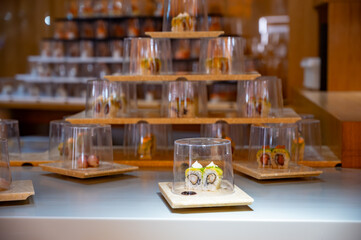 Japanese cuisine, modern restaurant with sushi, sashimi, other Japanese dishes served on moving belt across restaurant, self-service lunch cafe