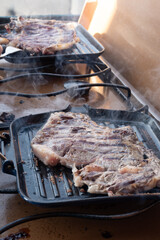Large beef rib eye steak grilled on gas stove grill in small village restaurant in Italy