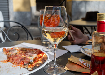 Glass of cold dry white wine served outdoor in cafe in Bellagio, Como lake, Italy
