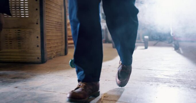 Worker, tool and person with hammer walking in workshop with smoke or dust from construction. Industrial, sledgehammer and working in warehouse on building, project or demolition with safety