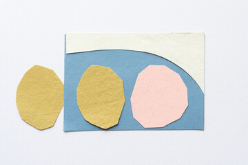 three polygonal paper shapes and blue post card with curve border