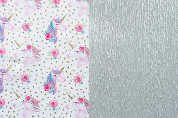 fabric with unicorn print pattern and metallic silver crepe paper