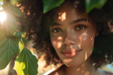 Natural sunlight dapples the face of a serene young woman amid lush greenery, a picture of tranquility.

