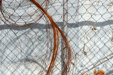 rusty wire on a chain link fence outside