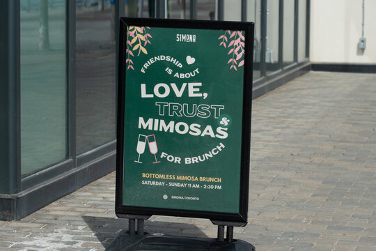 outdoor sign for Simona, an Italian restaurant, located at 59 Merchants' Wharf in downtown Toronto, Canada